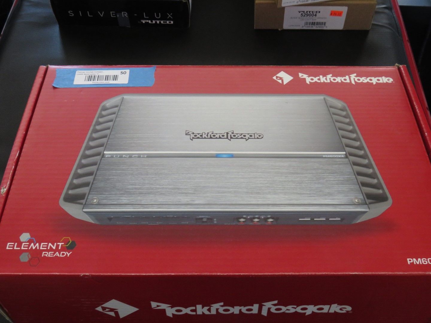 Rockford Fosgate car amplifier in red box with silver top.