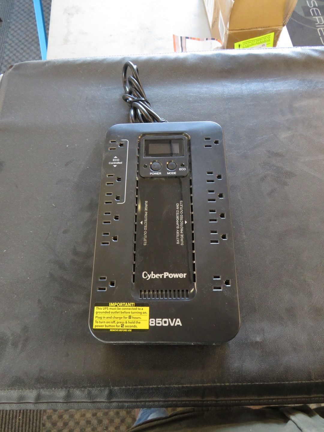 Black CyberPower uninterruptible power supply (UPS) with LCD display, outlets, and a power cable.
