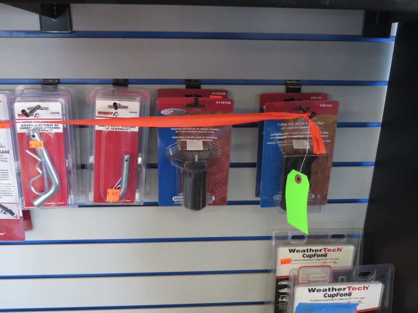 Hardware items in packaging hanging on display shelves.