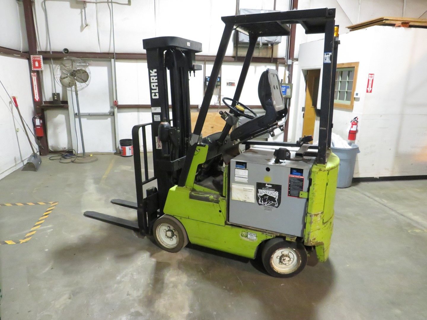 Green and black Clark forklift in a warehouse setting.