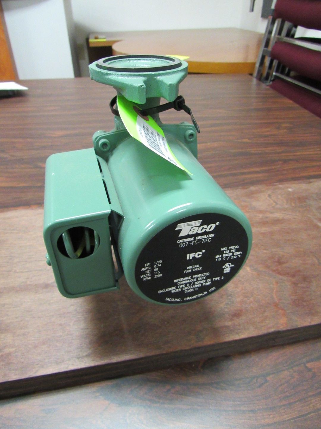 Green Taco 190 circulator pump on a wooden surface.