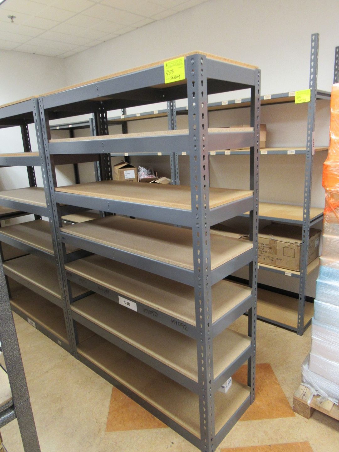 Metal storage shelves in a store or warehouse. Shelves are empty.