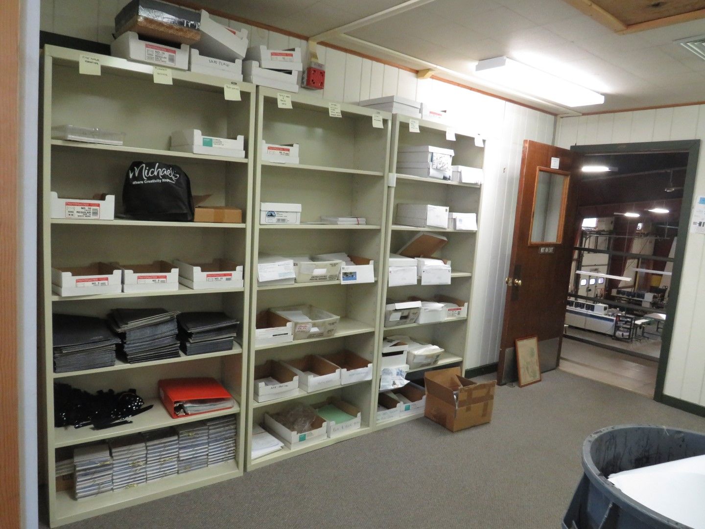 Shelves filled with boxes and supplies in a storage room.