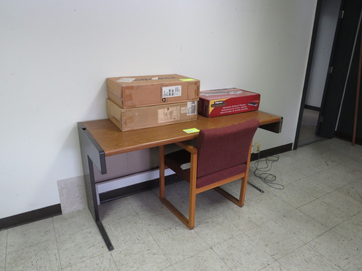 Desk with two boxes and a chair.