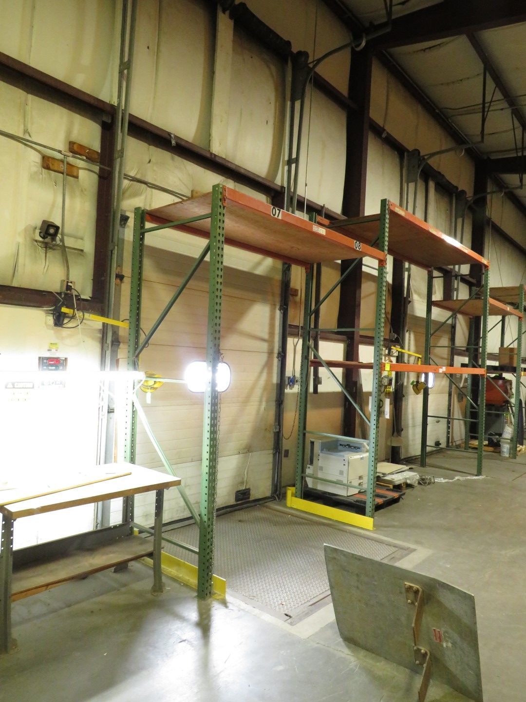 Warehouse with metal shelving, loading dock, and overhead lighting.