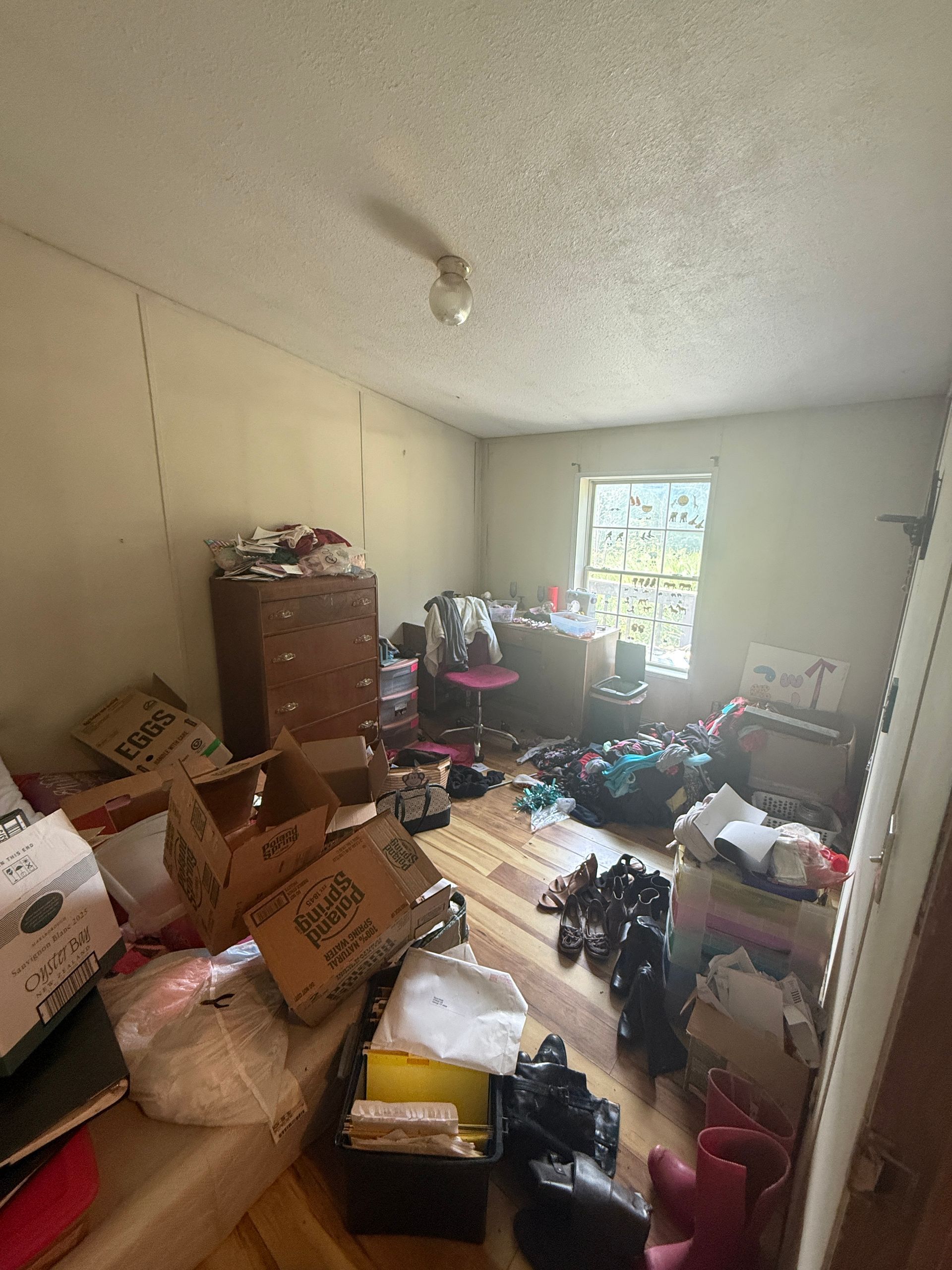 room with stacked boxes and sunlight from a window
