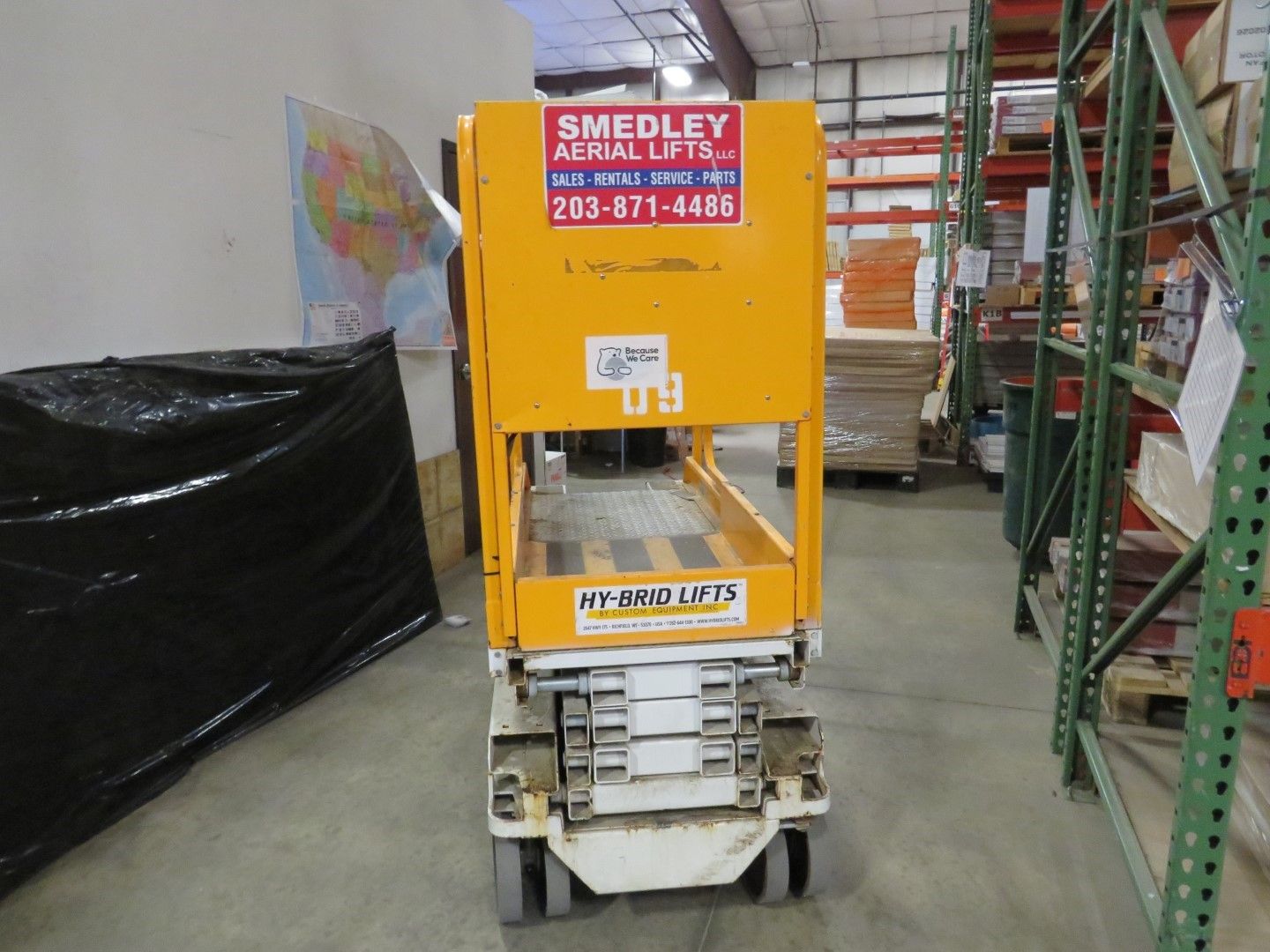 Yellow and white industrial lift in a warehouse.