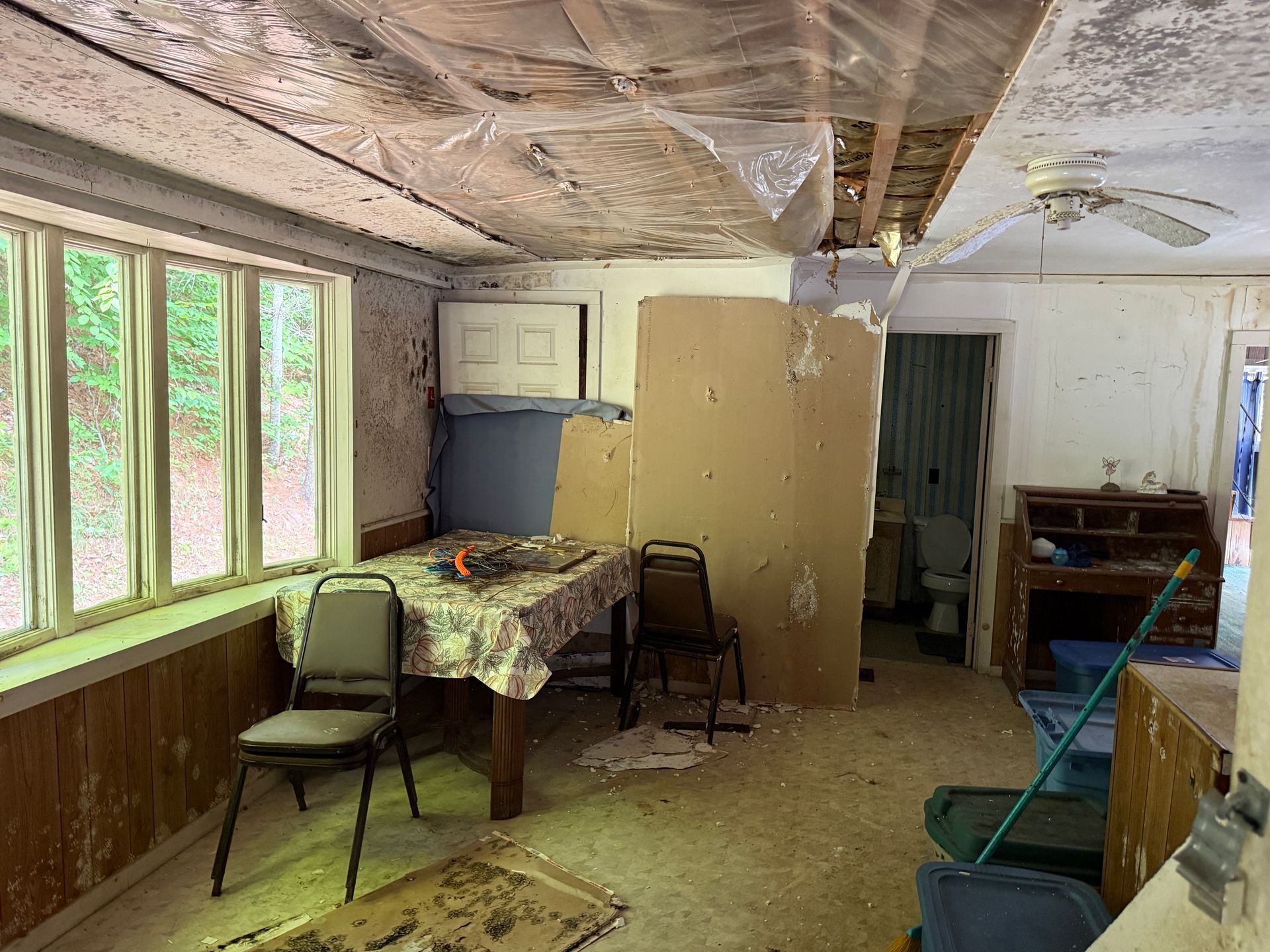 room with tables, chairs, windows, cabinets
