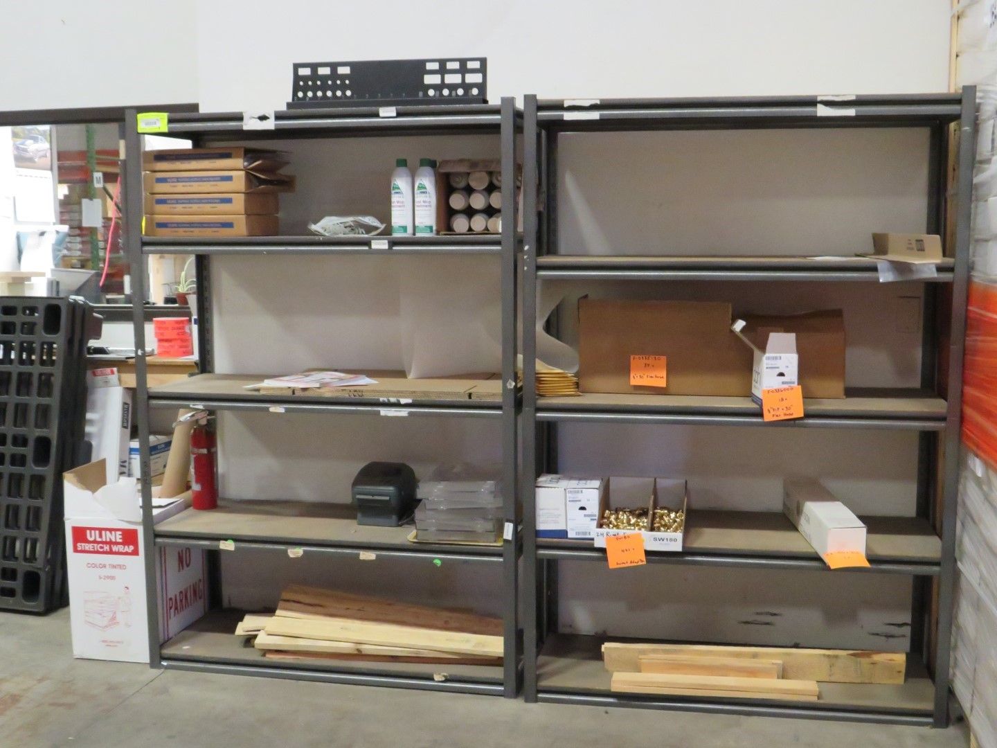 Metal shelving units with various items on some shelves.
