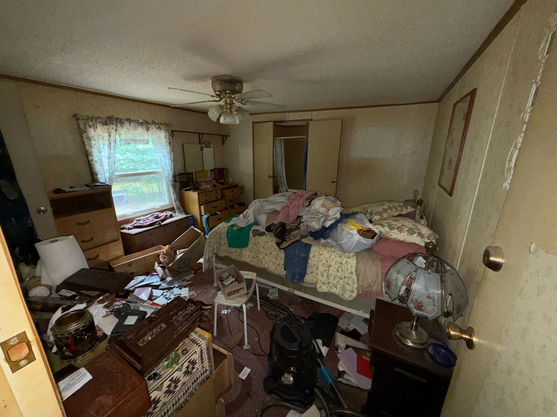 bedroom with an bed, clothes, and boxes