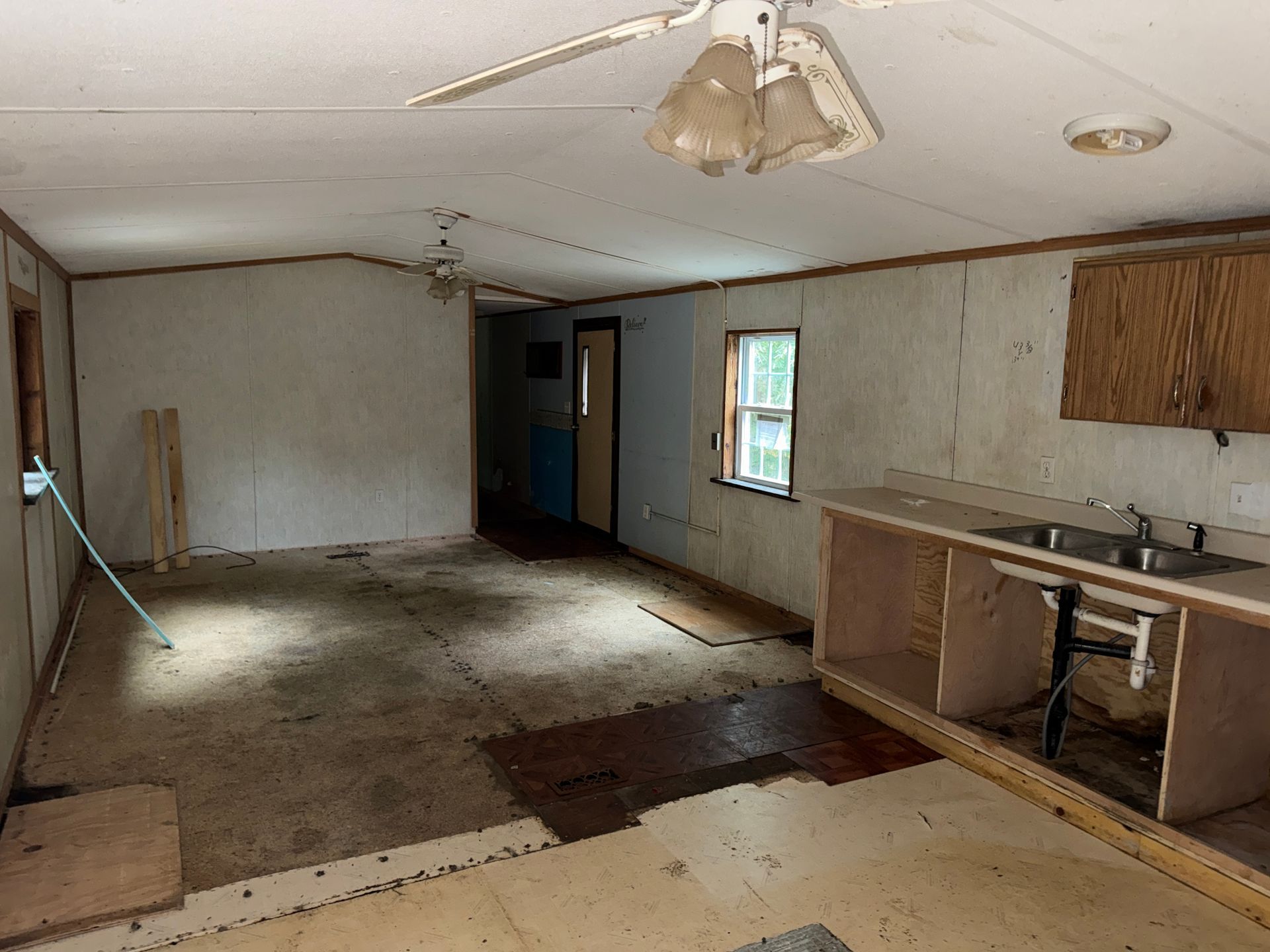 room with a small kitchen area on the right.