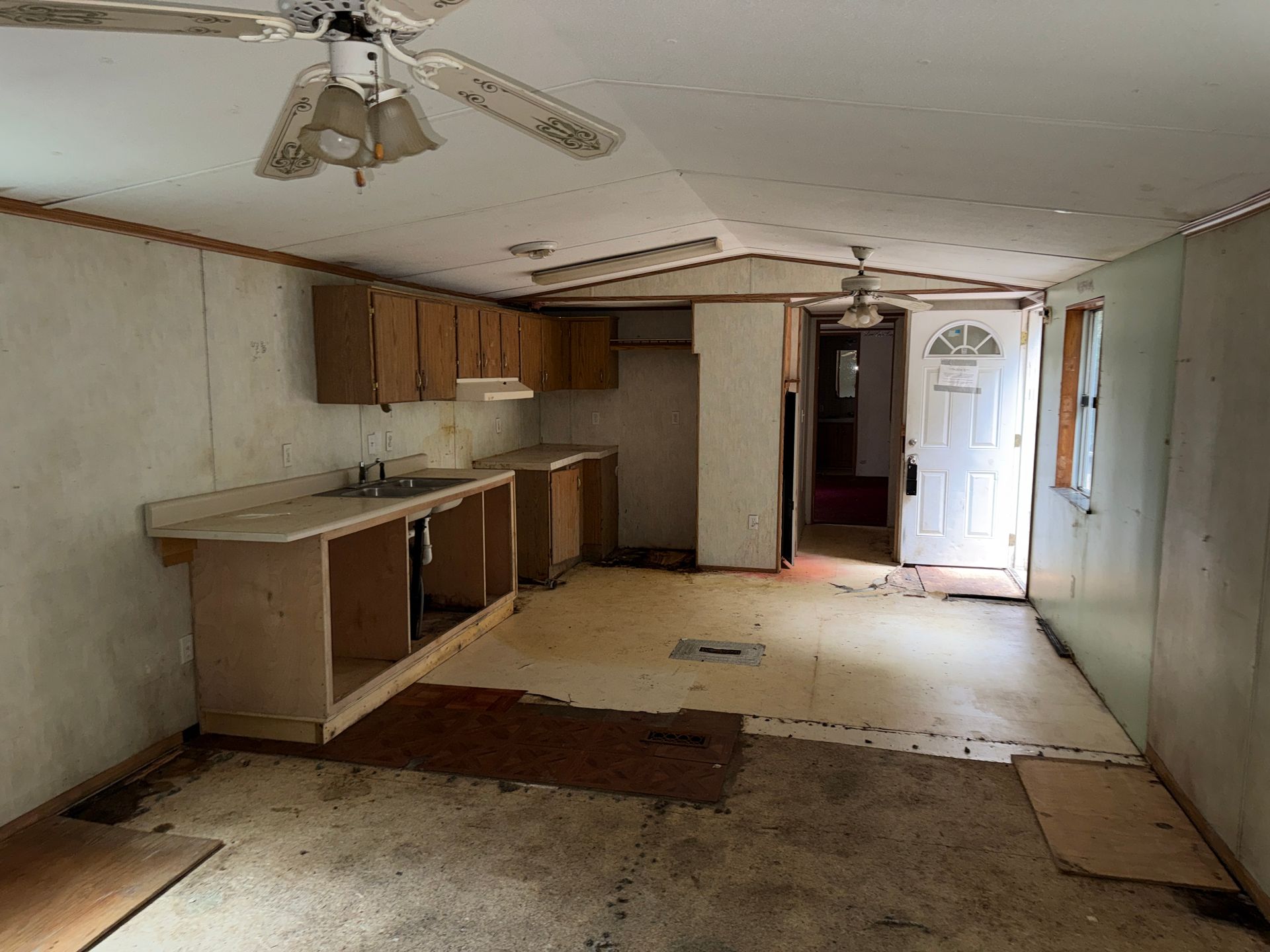 kitchen with ceiling, cabinets, and an open front door letting in light
