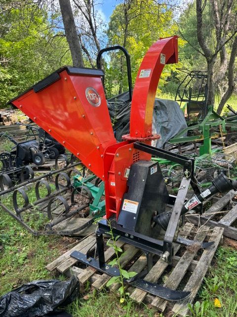 Red wood chipper on a pallet outdoors