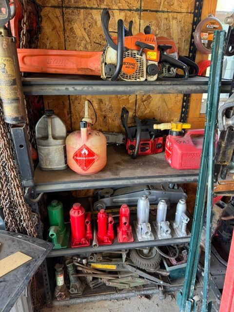 Shelved garage tools and gas cans on metal racks