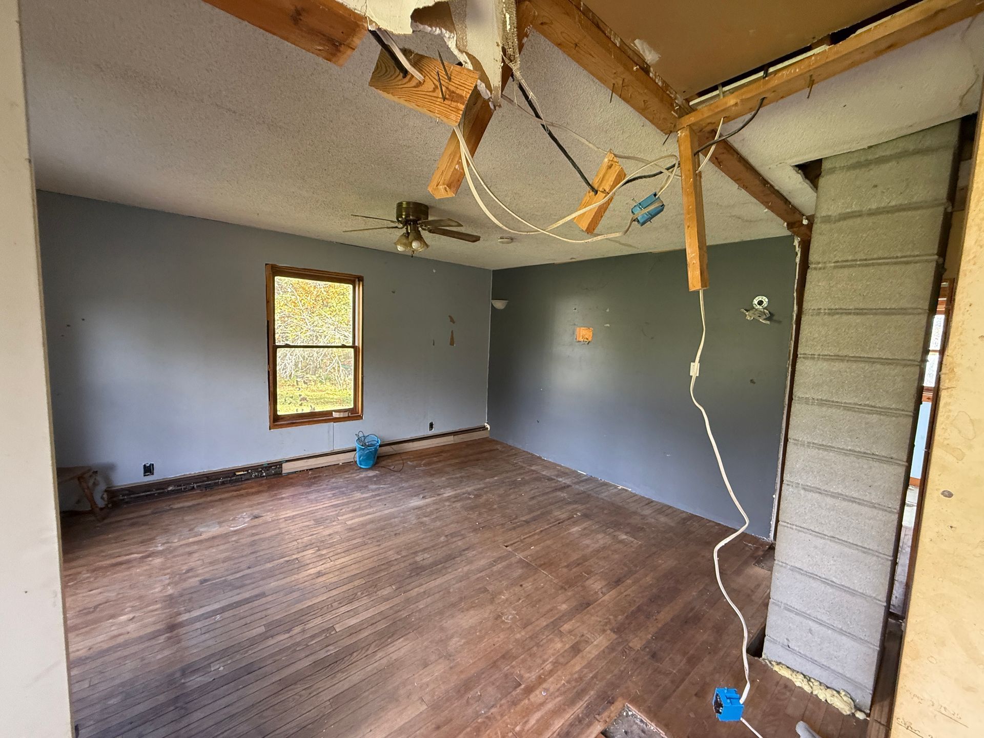 room with gray walls, and wood-look floor near a window.