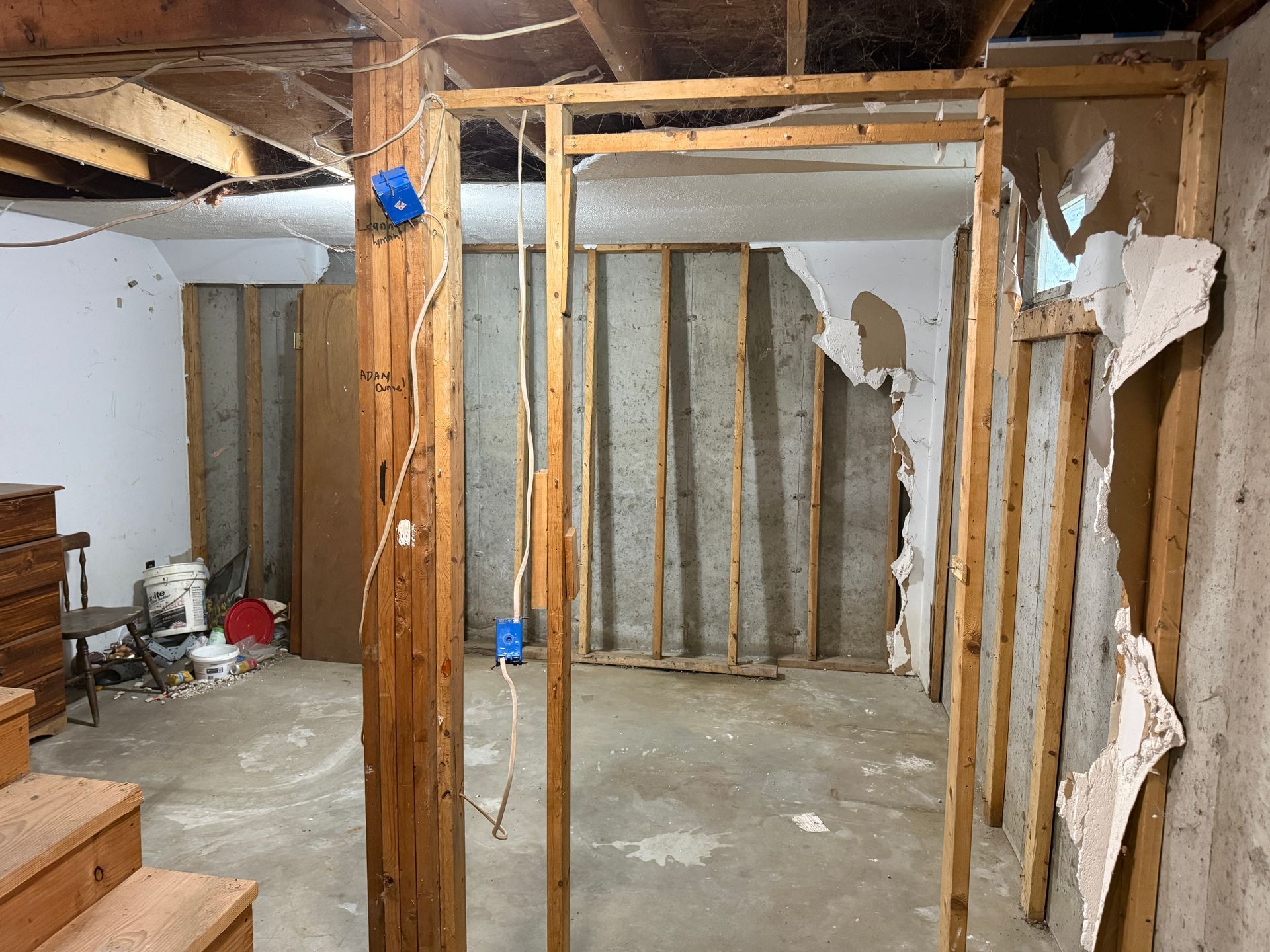 basement room with exposed wooden studs, insulation, and concrete floor