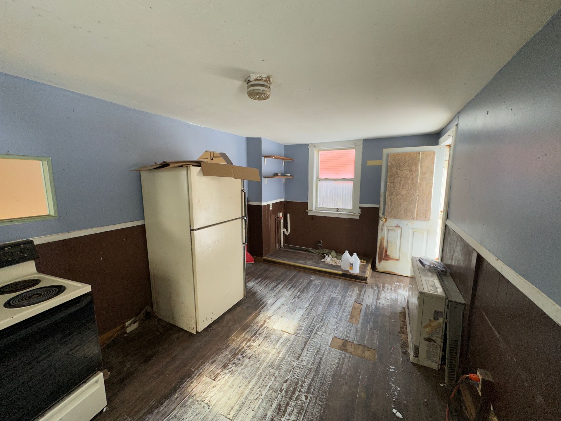 Kitchen with blue and brown walls, appliances.