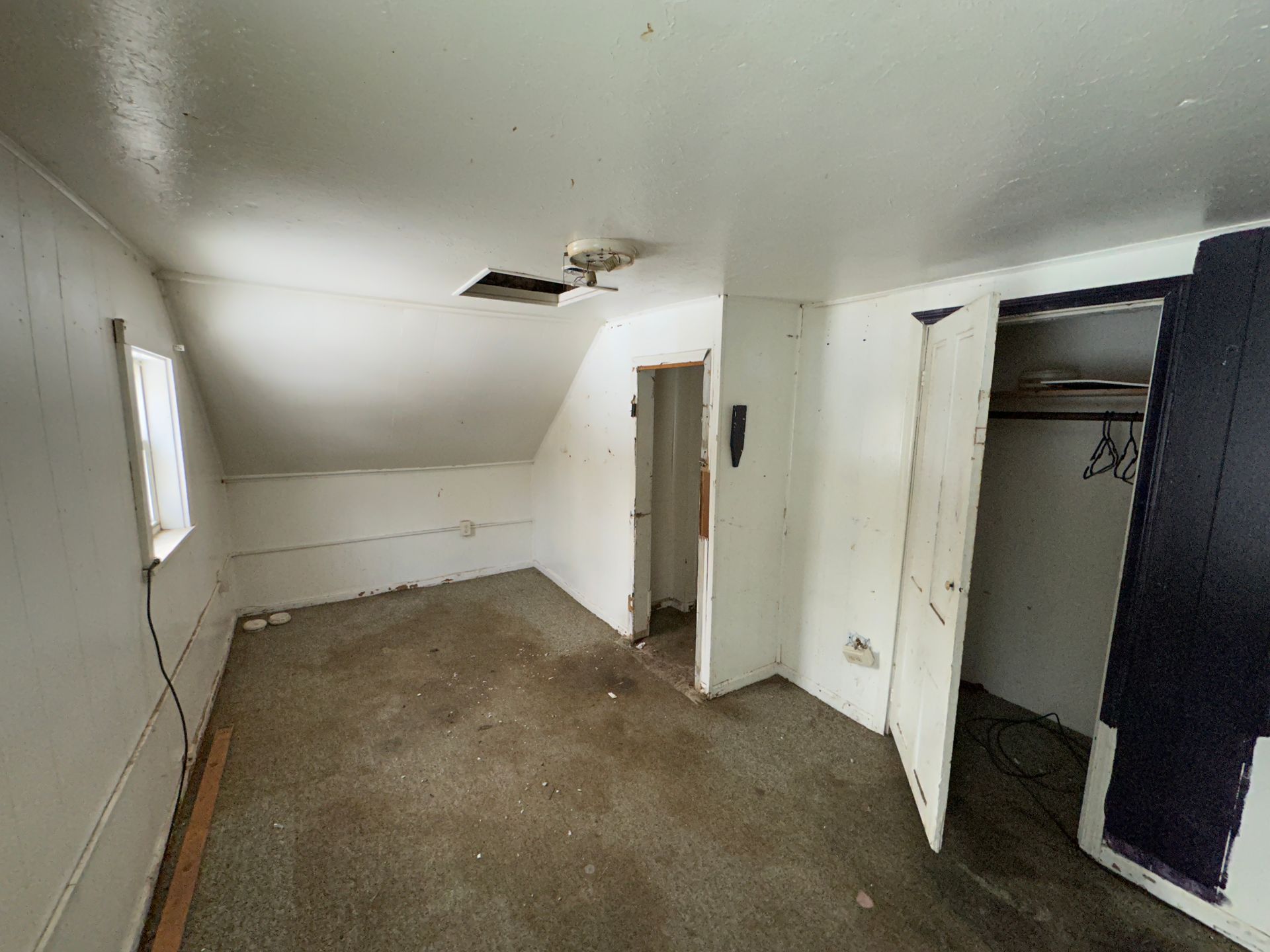 Room with white walls, a closet, and ceiling.