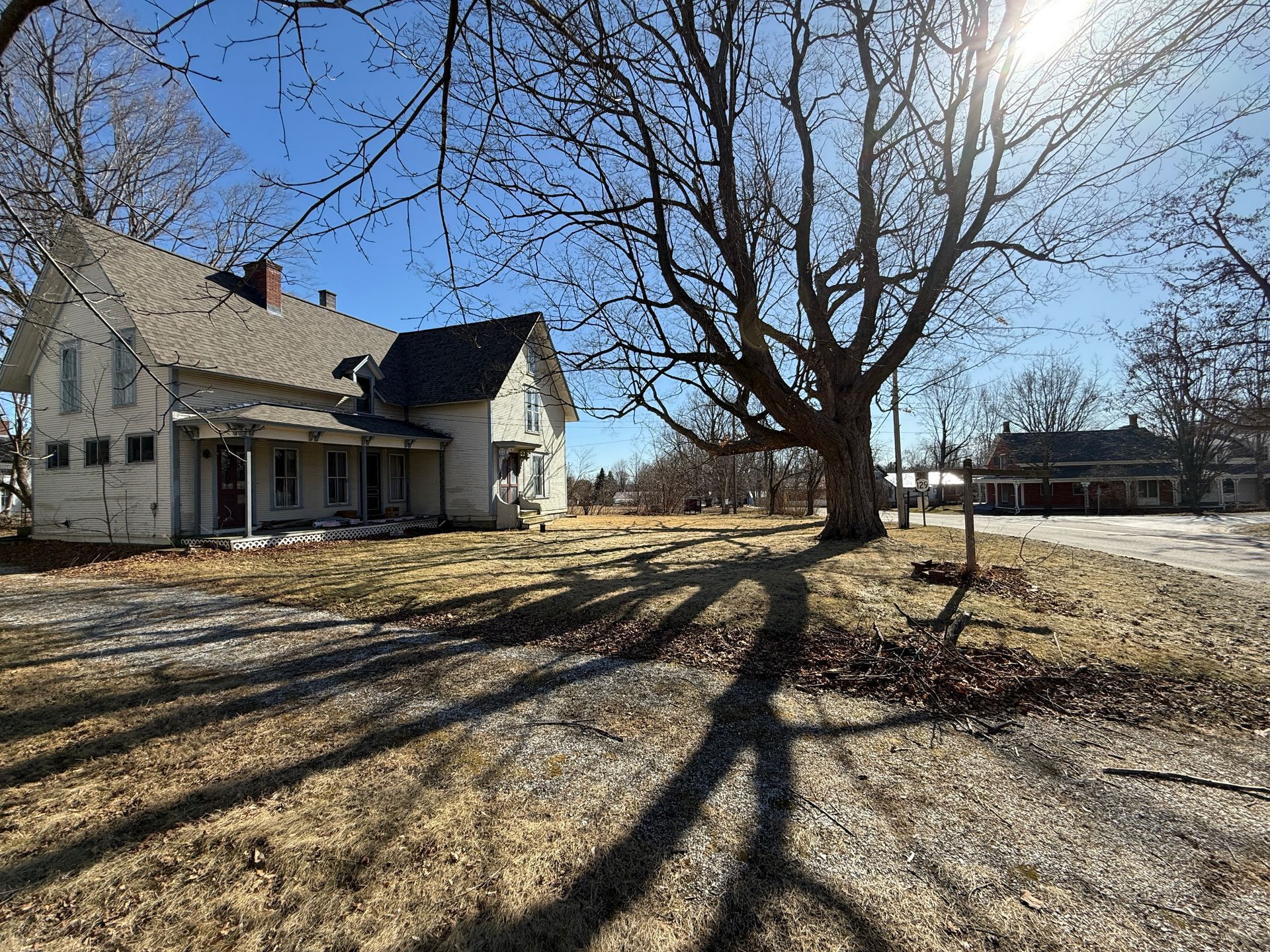 White house with porch on a sunny day.