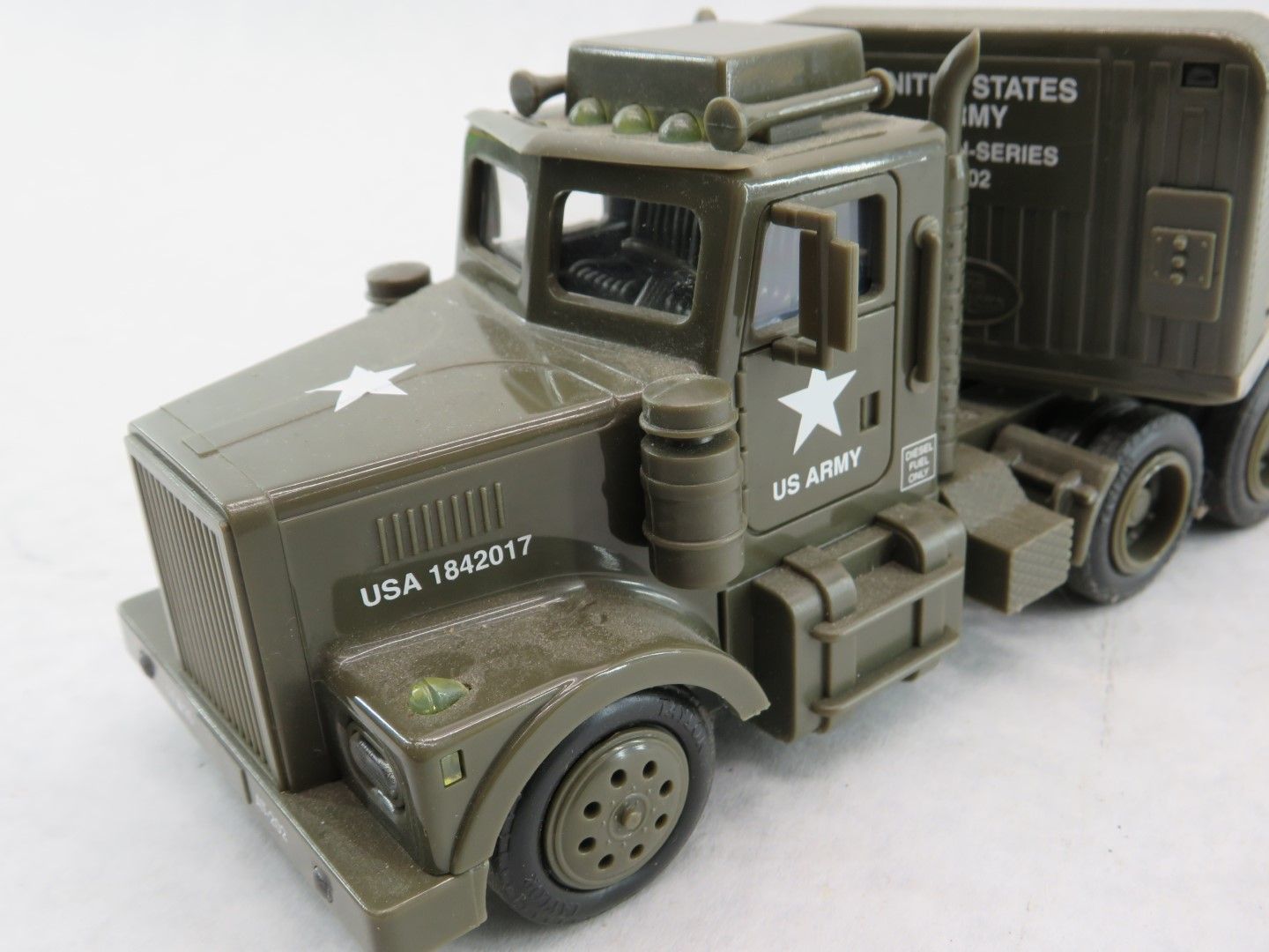 Toy military truck with trailer, olive green, white stars, and 