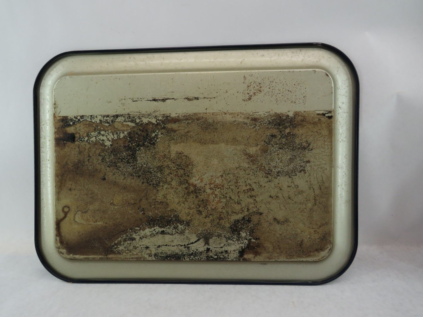Rectangular metal tray with a black border.