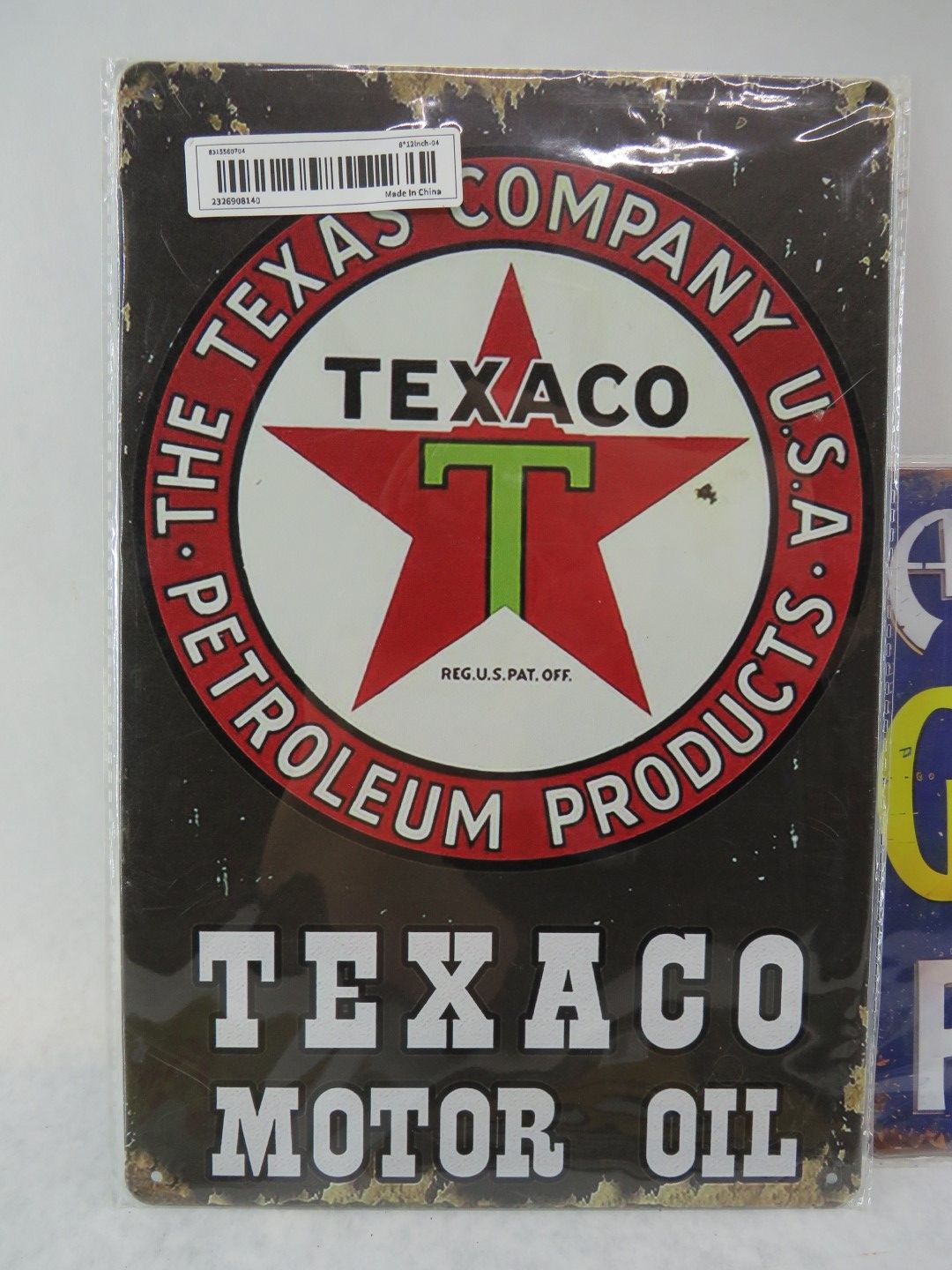 Vintage Texaco Motor Oil sign with red star logo.