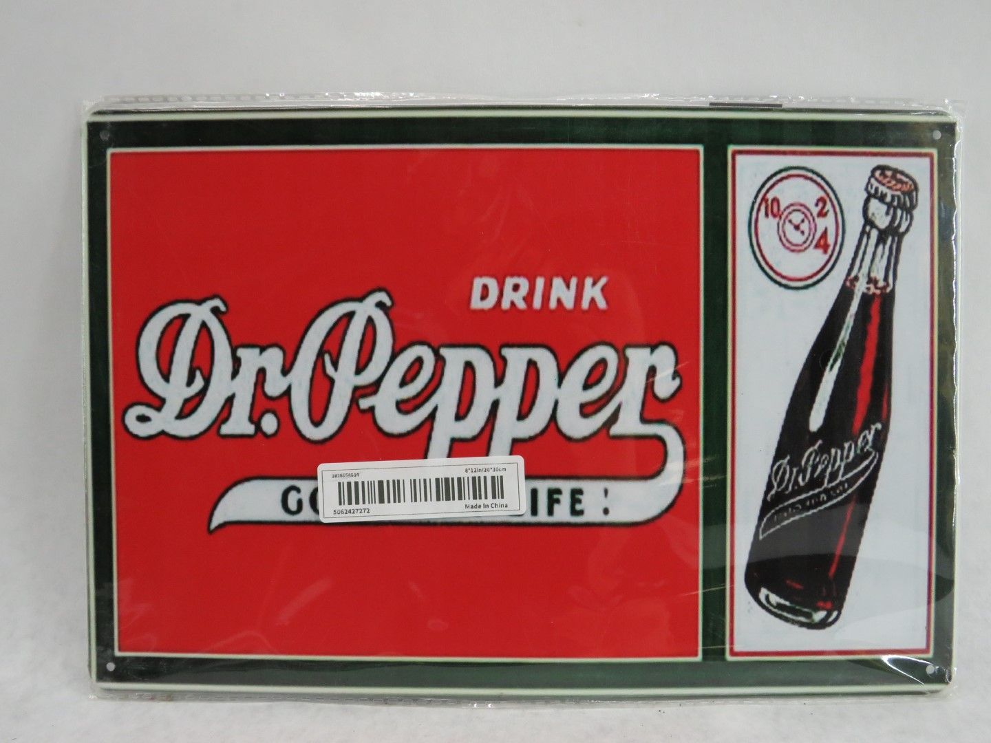 Dr. Pepper sign with logo on red, bottle illustration on white, and green border.