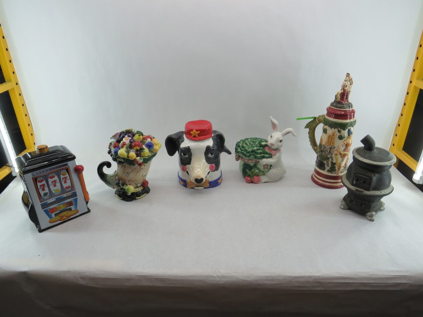 Collection of six novelty ceramic containers, various shapes including a slot machine, panda, and rabbit.