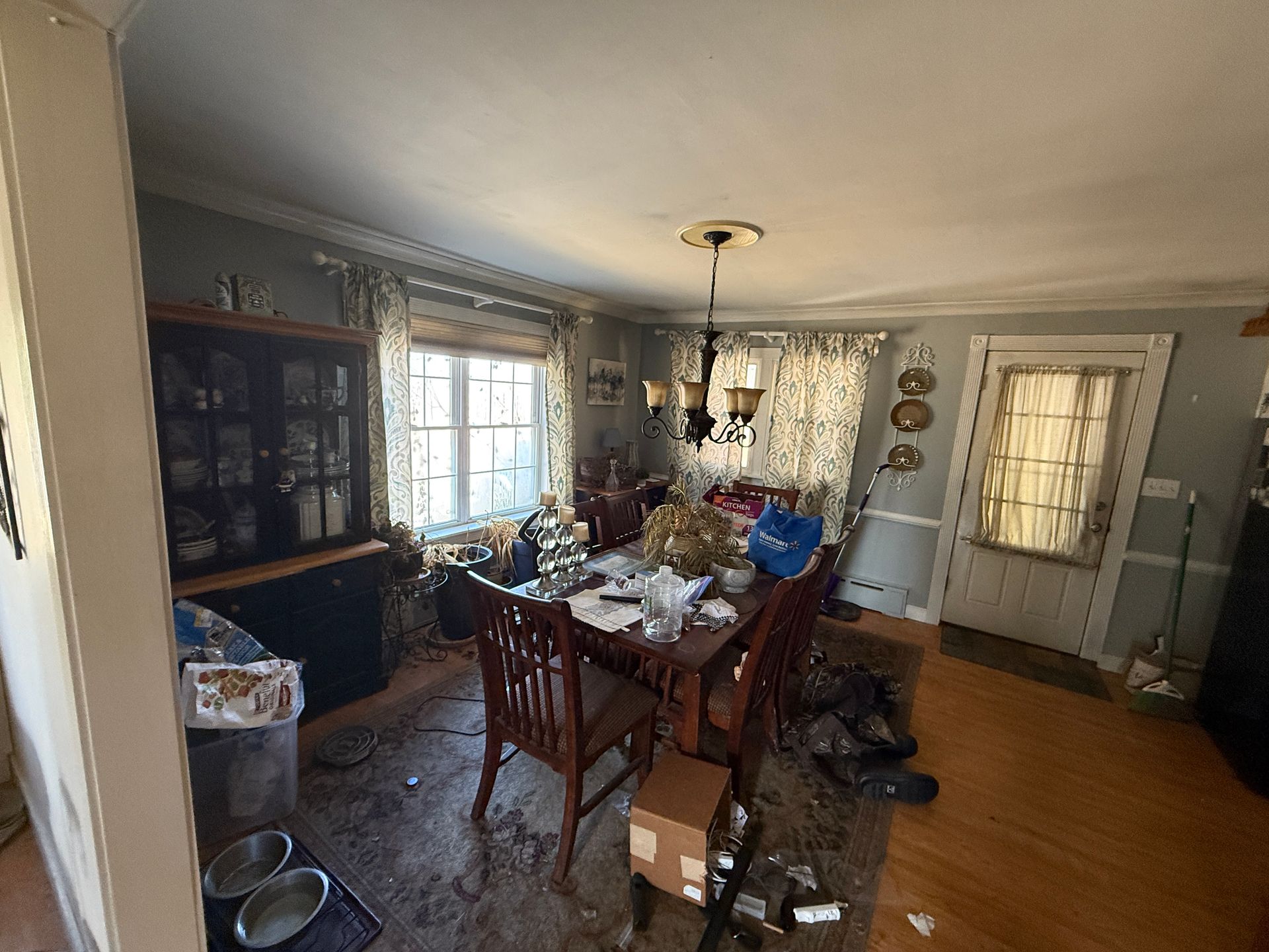 Dining room with table, chairs, hutch, window.