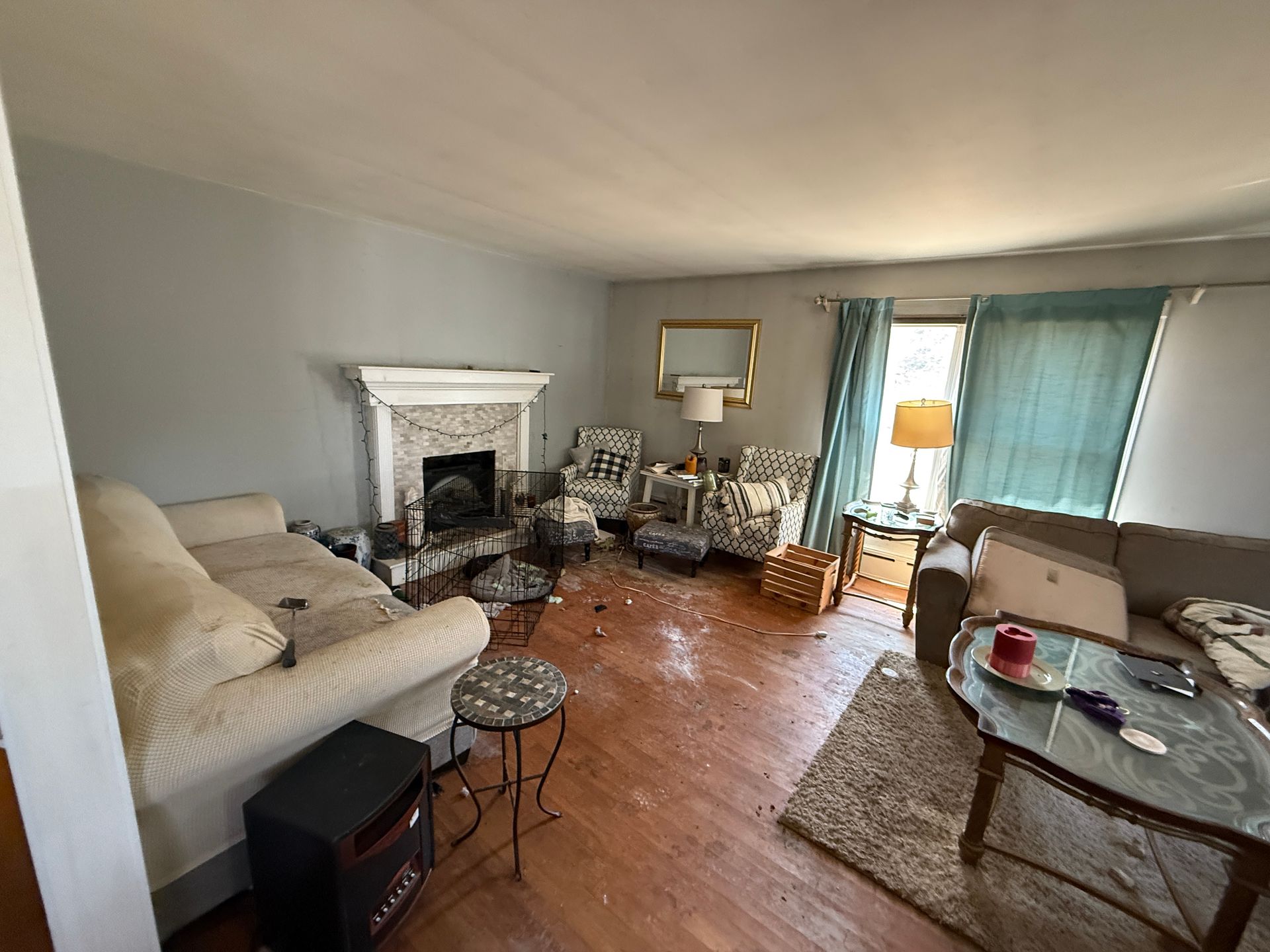 Living room with light blue walls, fireplace, and furniture.