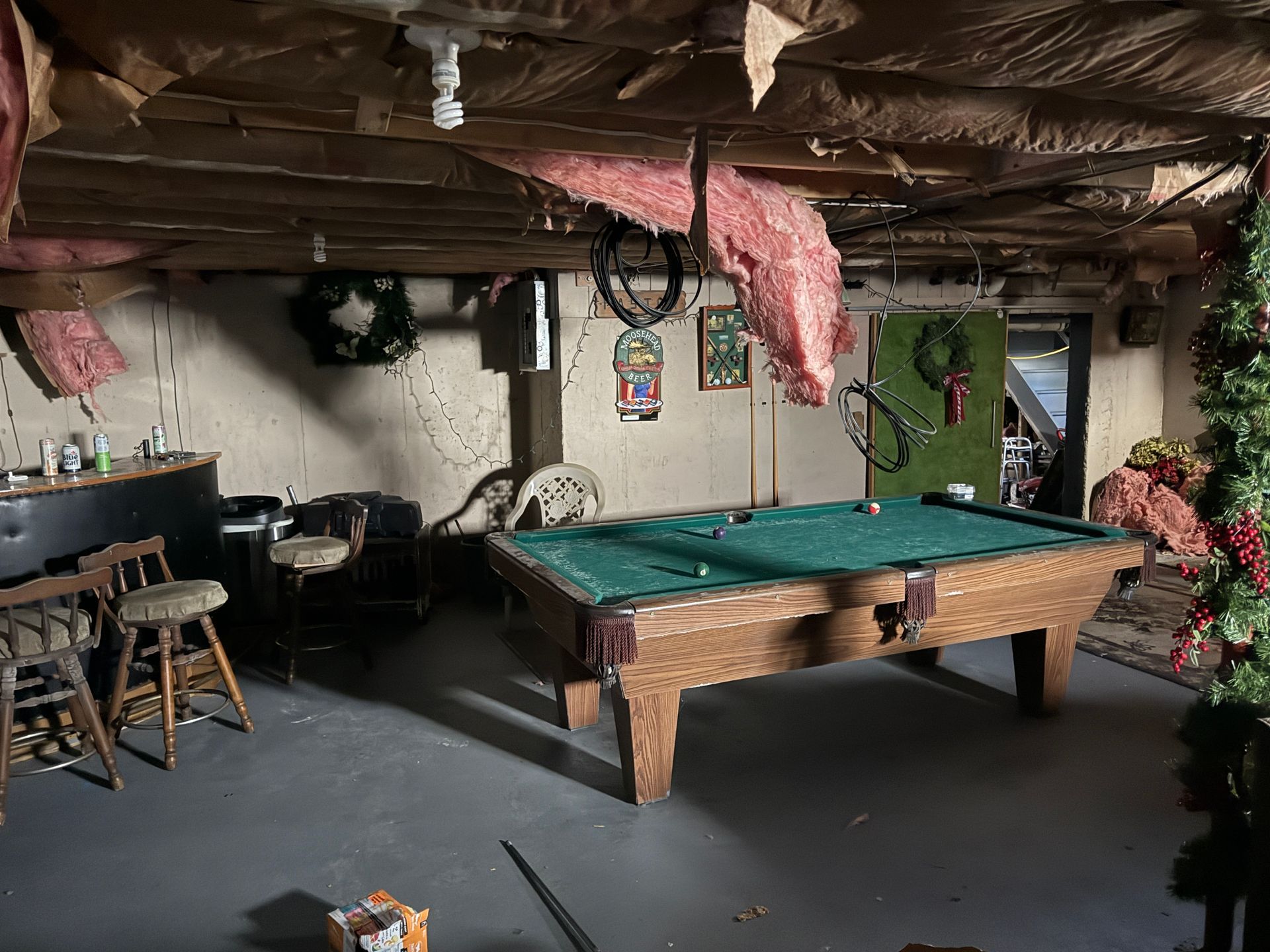 A basement with a pool table, bar.