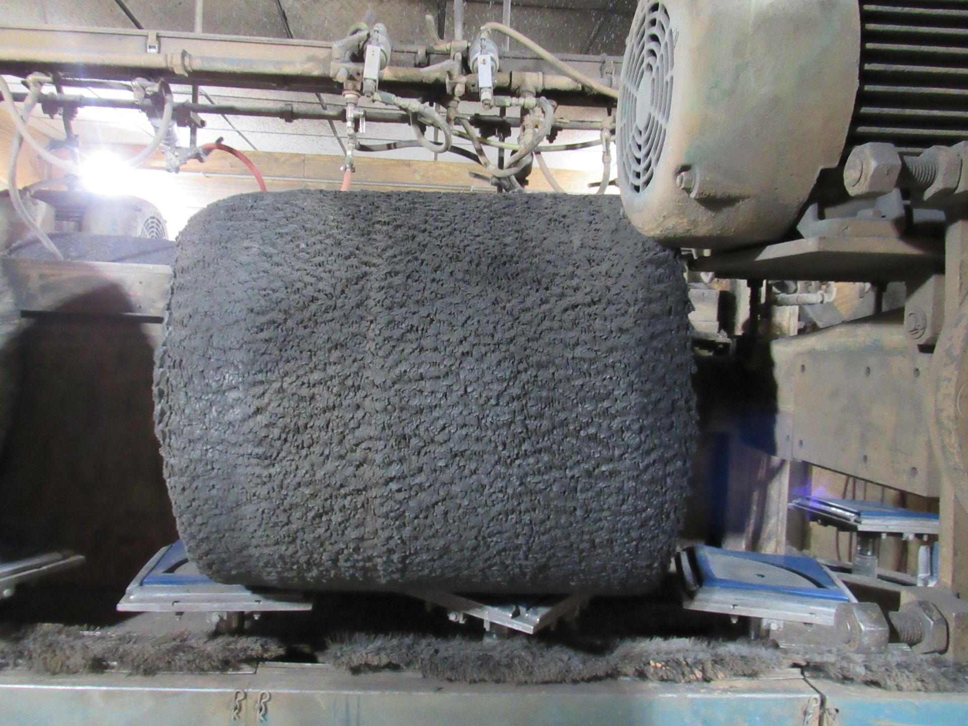 Large, square, gray buffing brush.