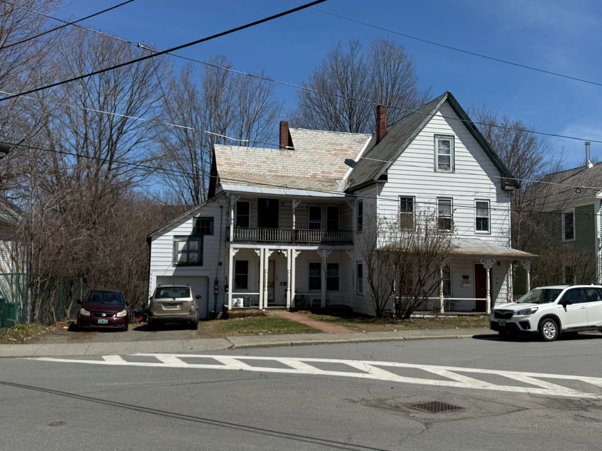 White two-story house with front porch.