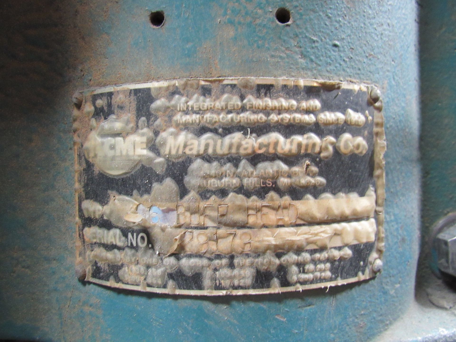 A  metal label on teal machinery. 