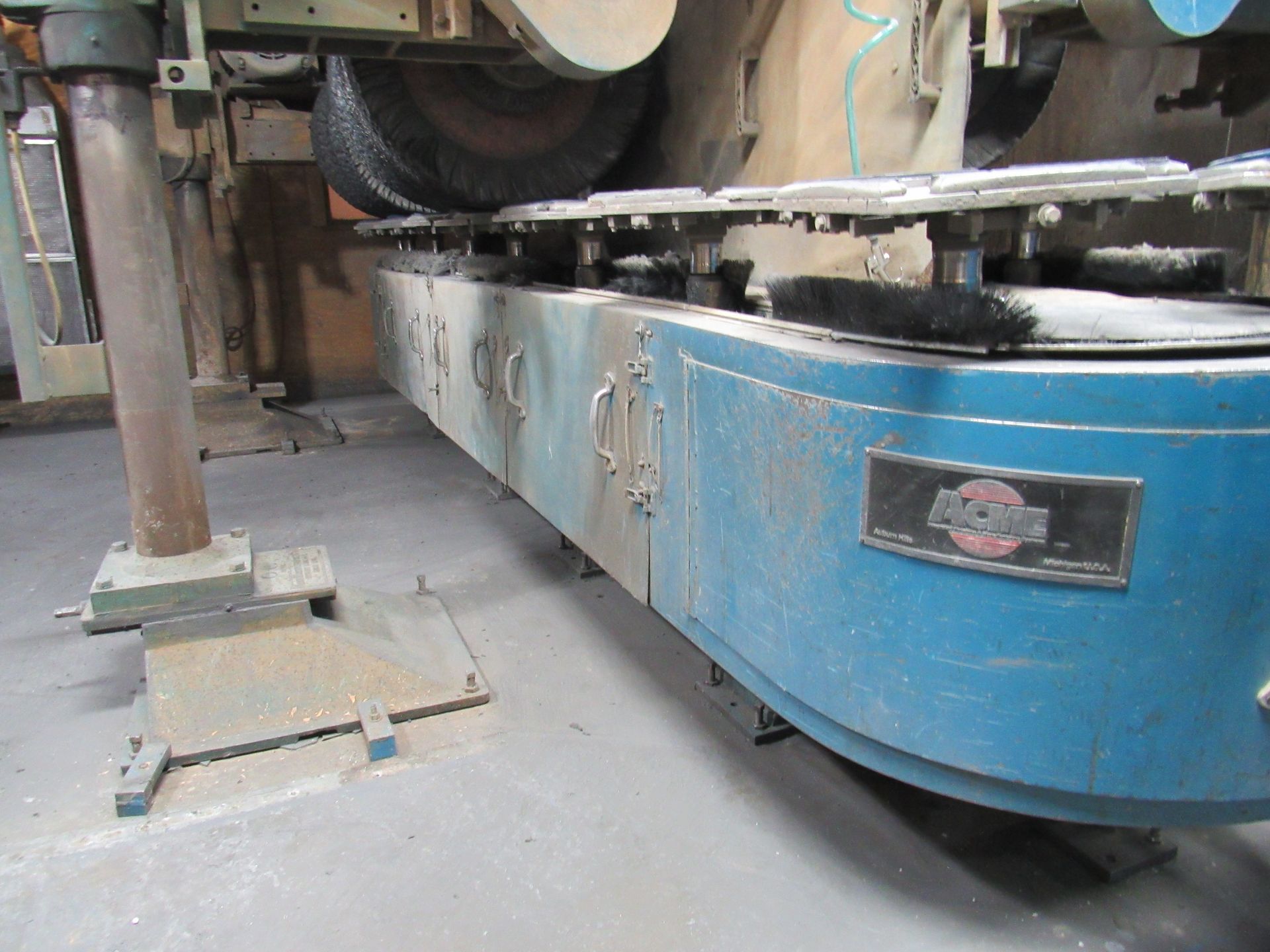 Industrial stone grinding machine with a blue and gray body.
