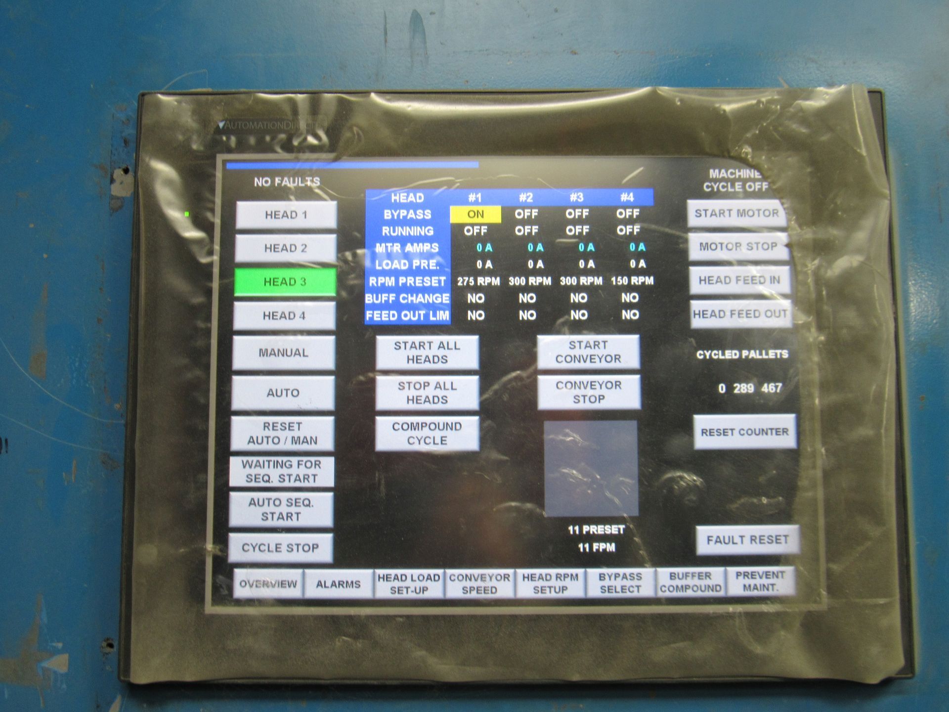 Touchscreen control panel with buttons and display for an industrial machine.