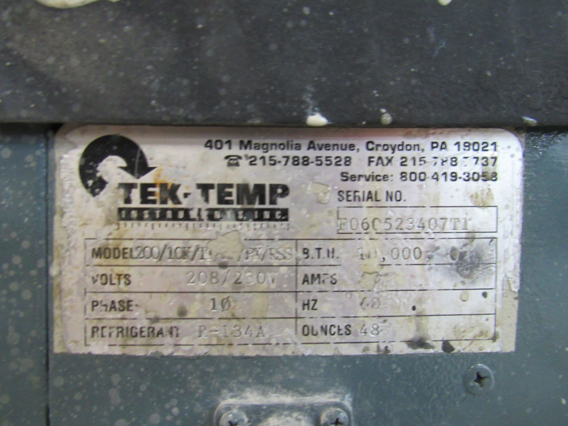 Label on a Tek-Temp refrigeration unit with model and serial numbers, voltage, and other specifications.