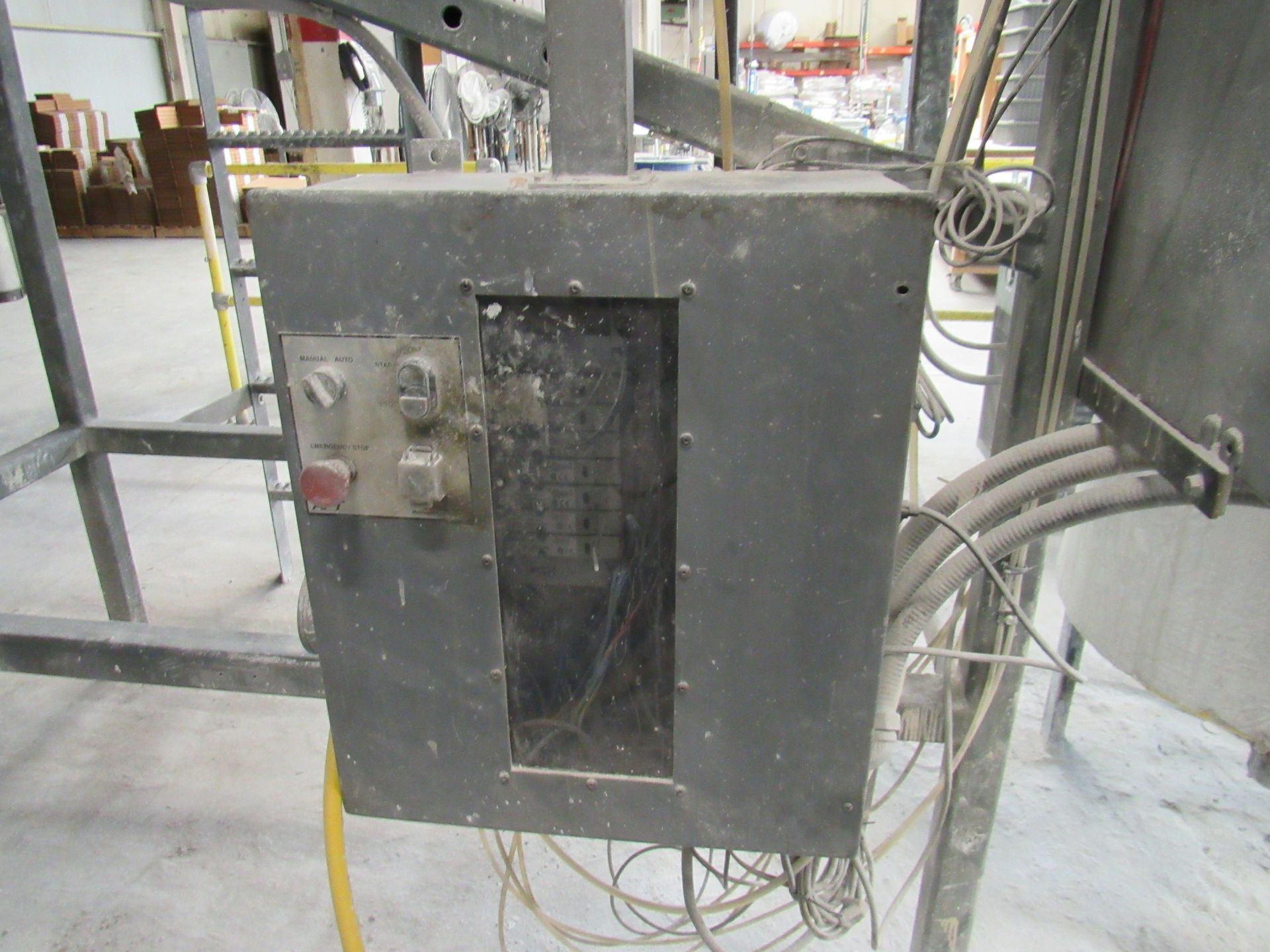 Gray electrical panel with visible circuit breakers and external wiring.