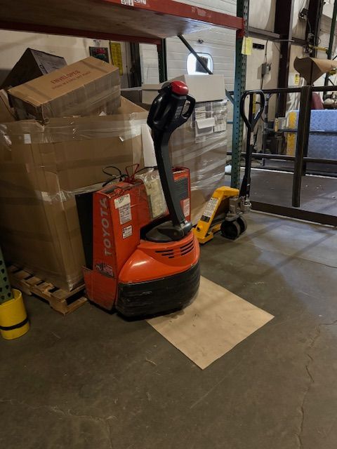 An orange Toyota electric pallet jack.