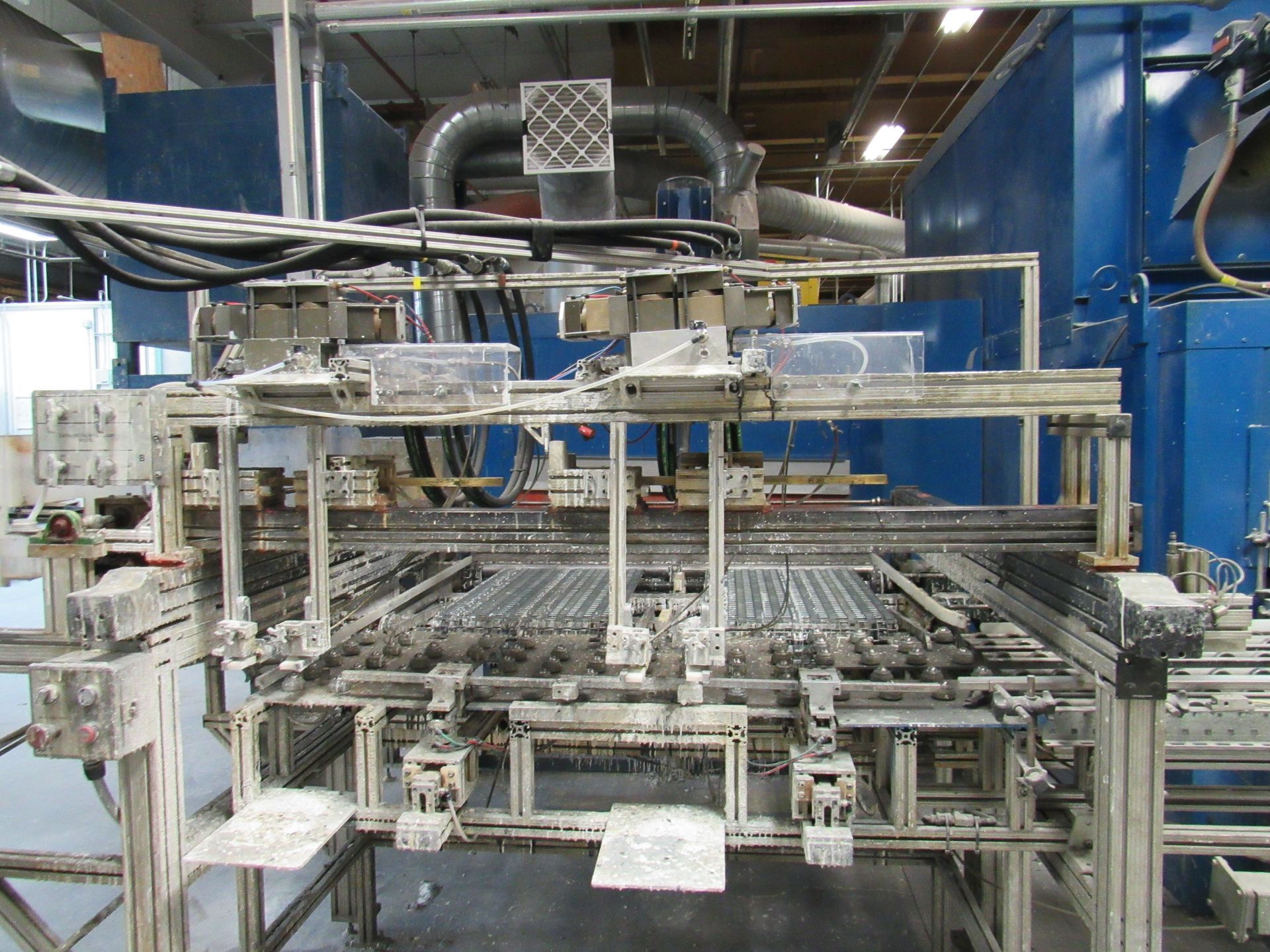 Industrial machinery with metal framing and conveyor belts.