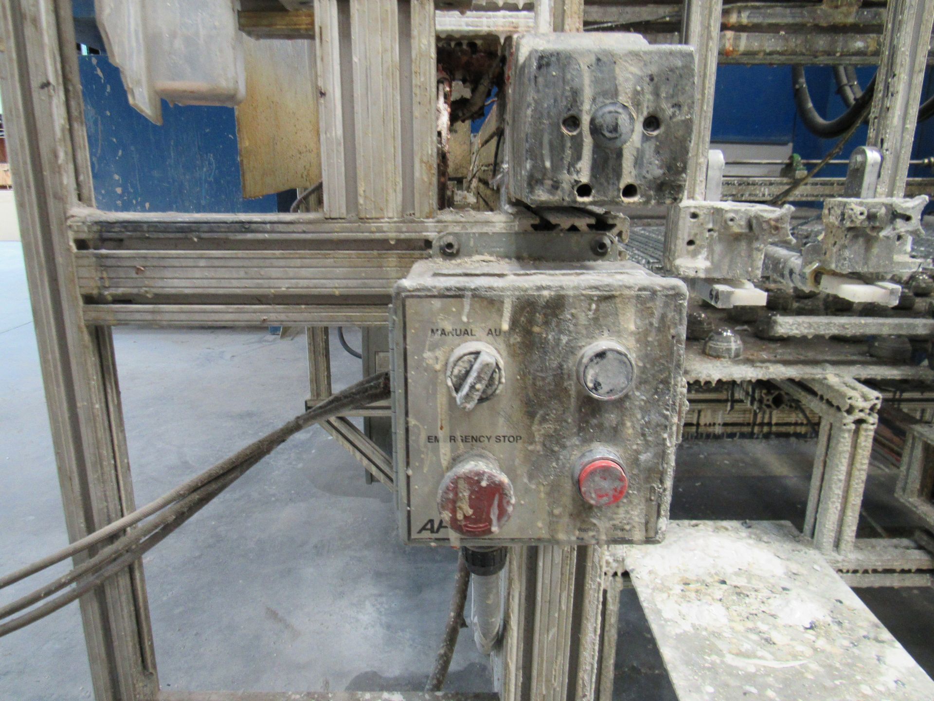 Control panel on industrial machine, with buttons and dials.