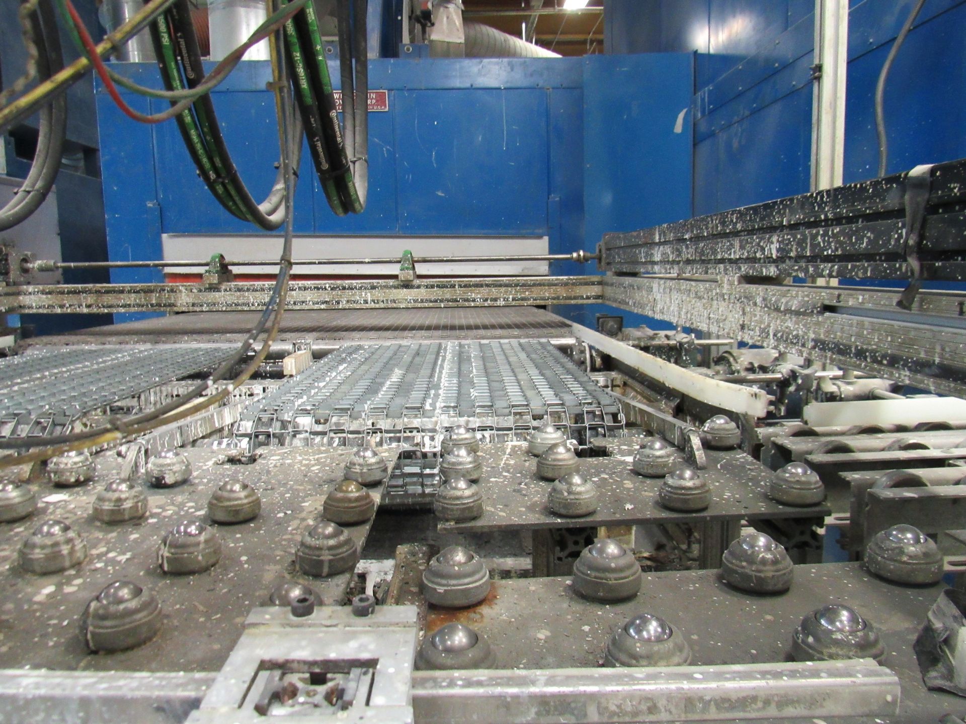 Industrial machine with metal rollers and components.