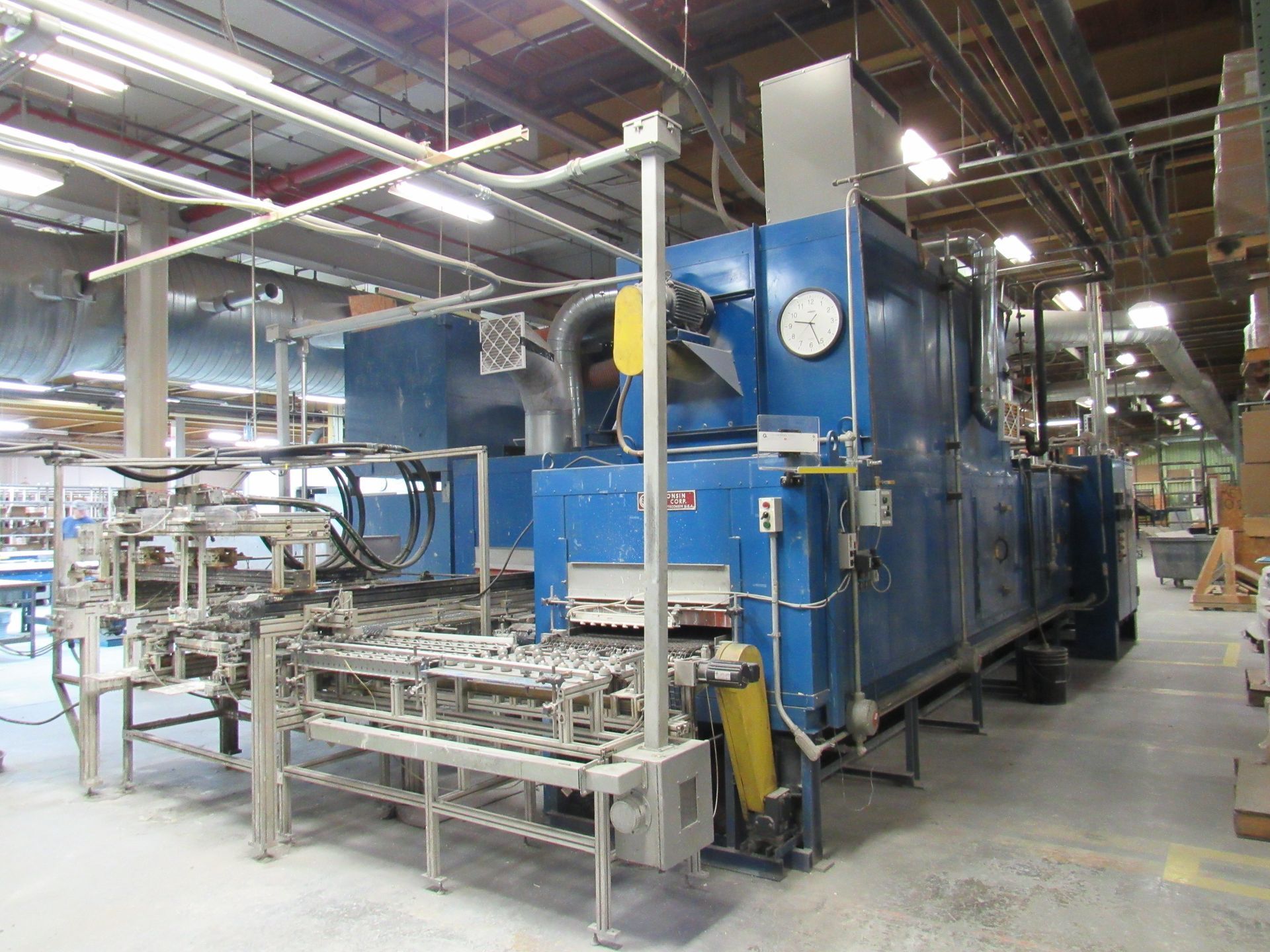 Blue industrial oven machine in a factory.