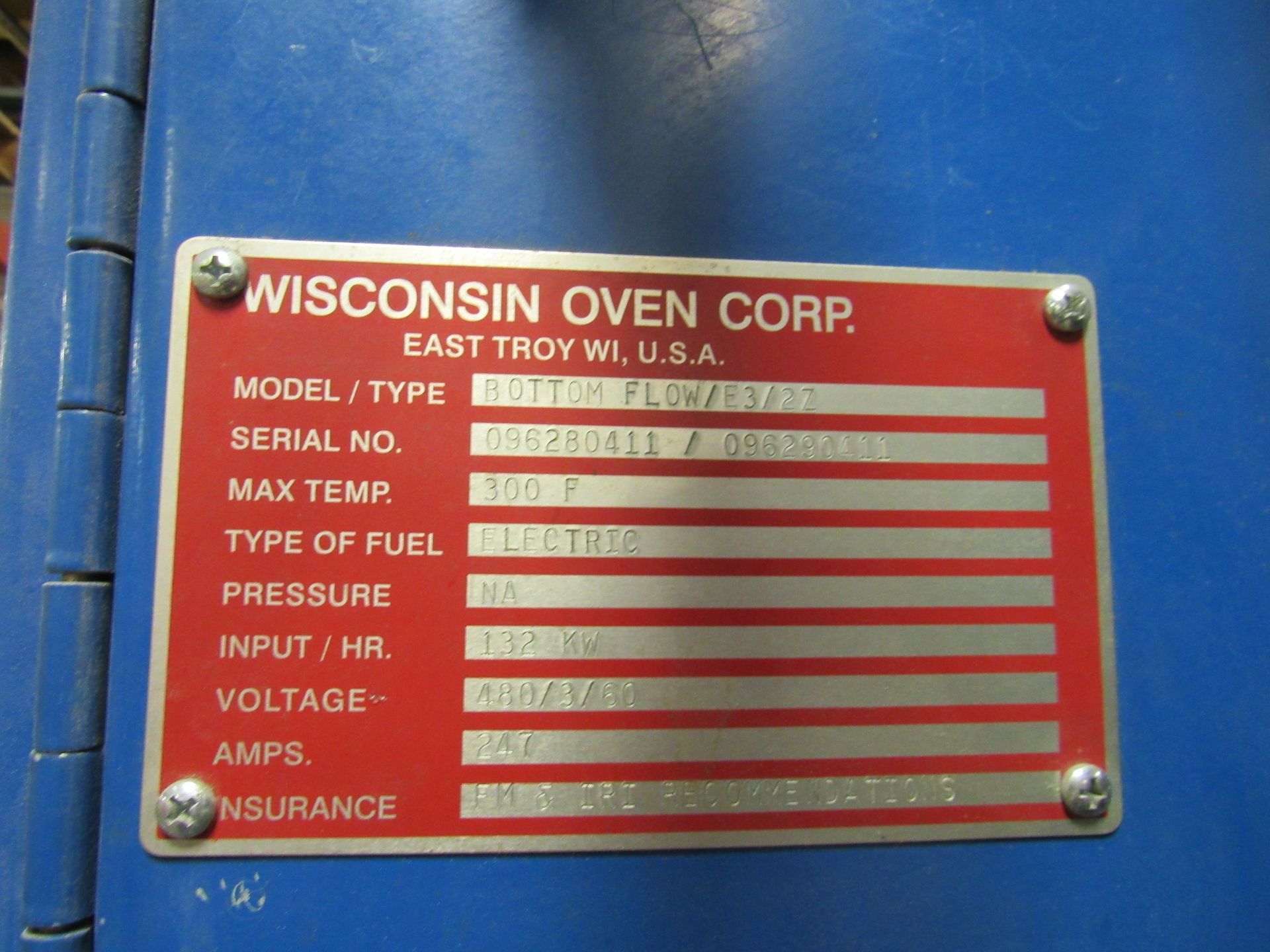 Red metal plate with details of a Wisconsin Oven Corp. oven.
