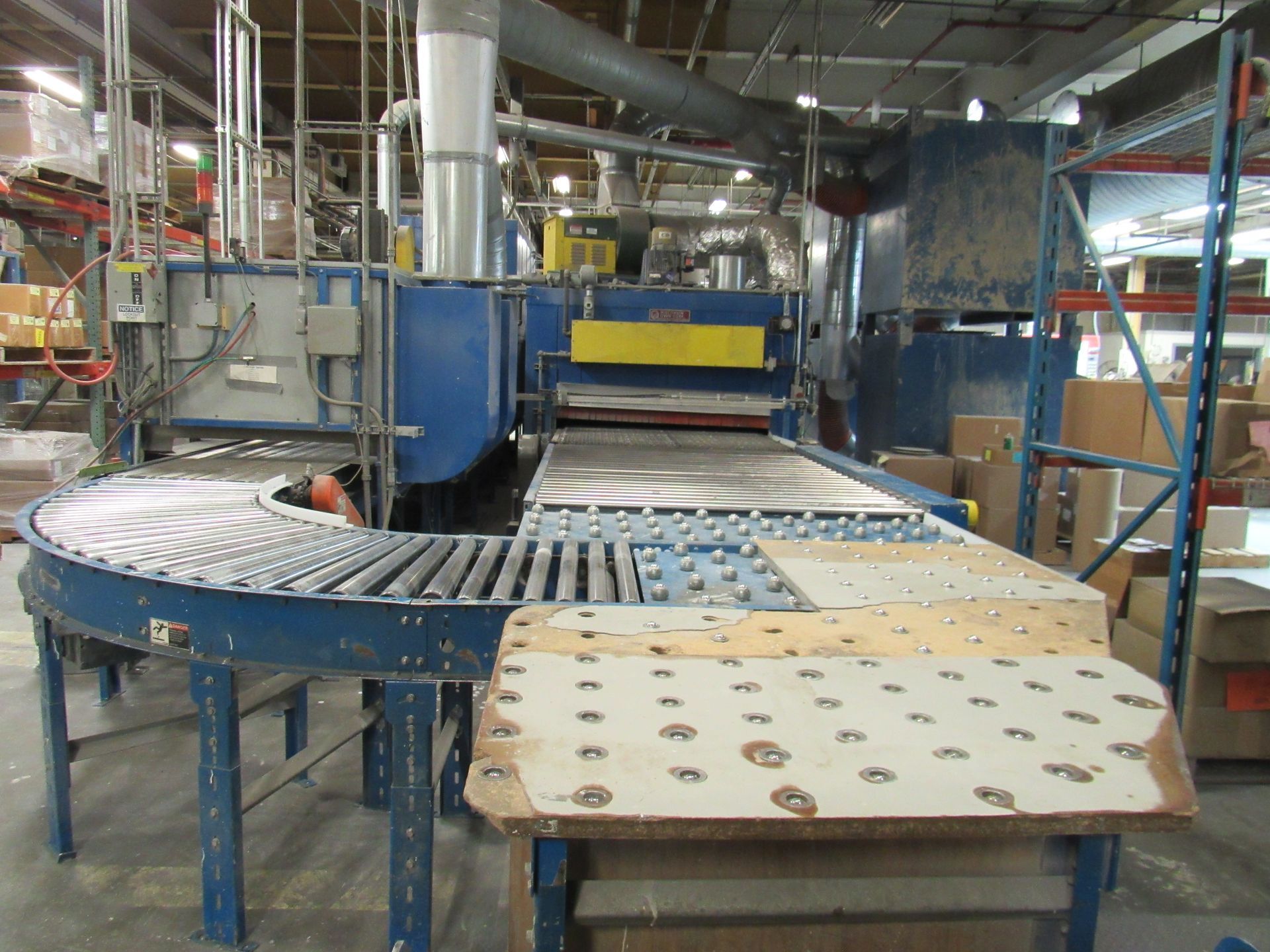 Industrial conveyor belt system with machinery. Blue and grey.