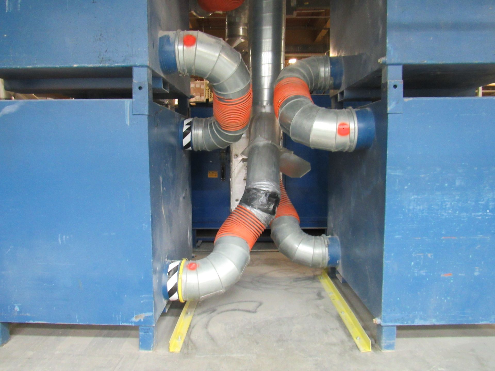 Blue industrial equipment with connected insulated pipes, gray, orange, black, and red.
