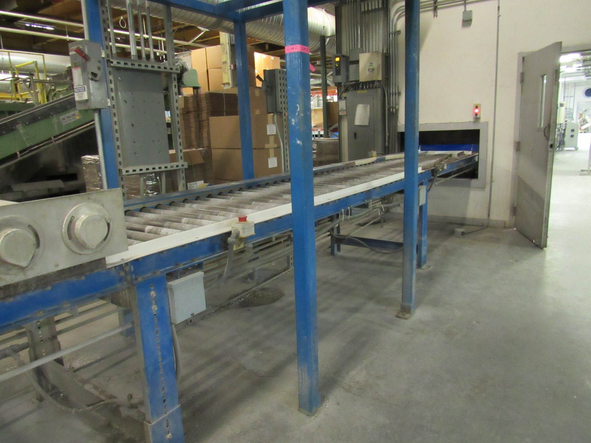 Blue industrial conveyor belt in a factory setting.