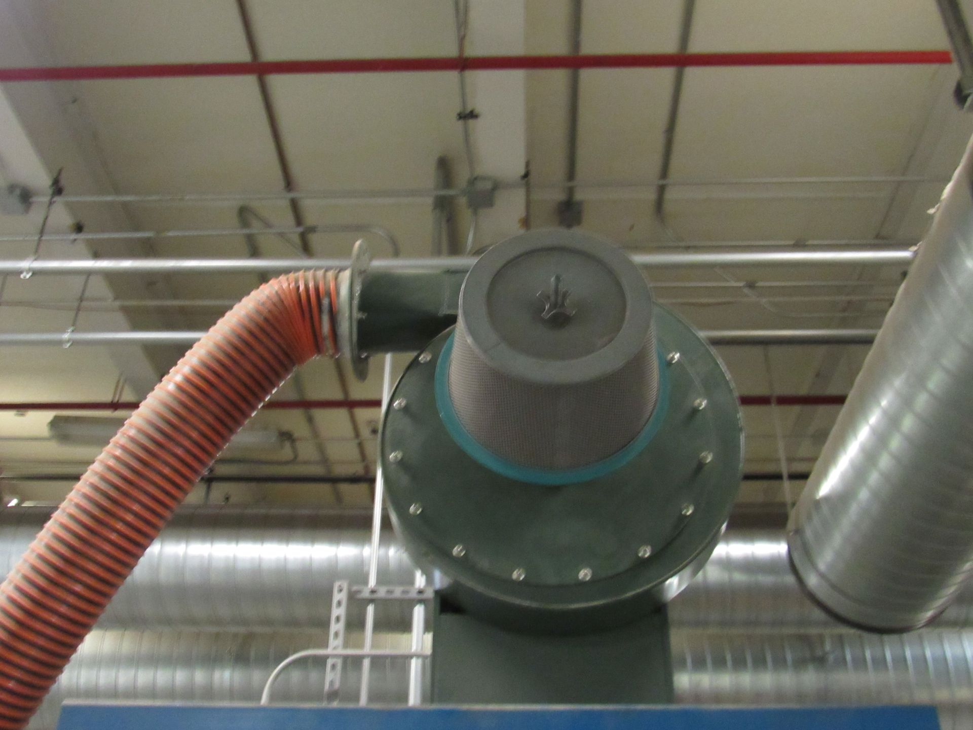 Industrial dust collector with flexible orange hose and metal ductwork.
