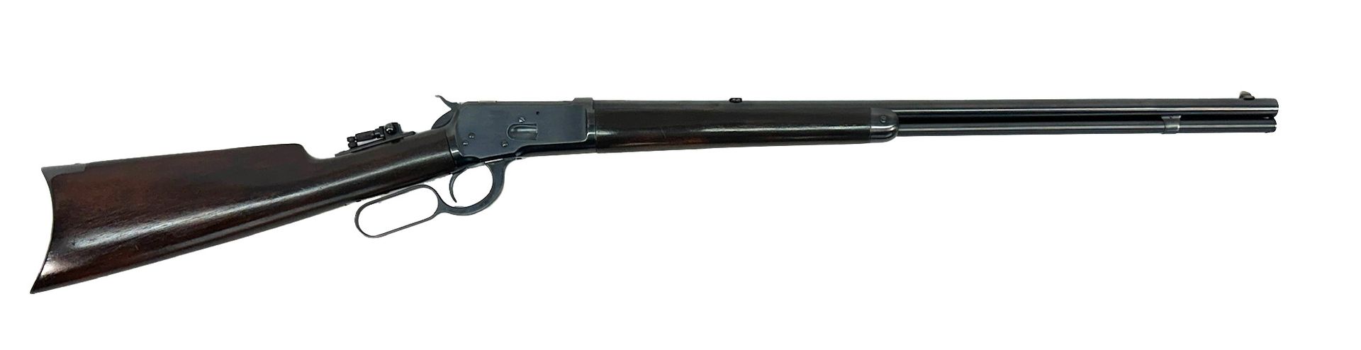 A lever-action rifle, dark wood stock and forend, dark metal barrel.