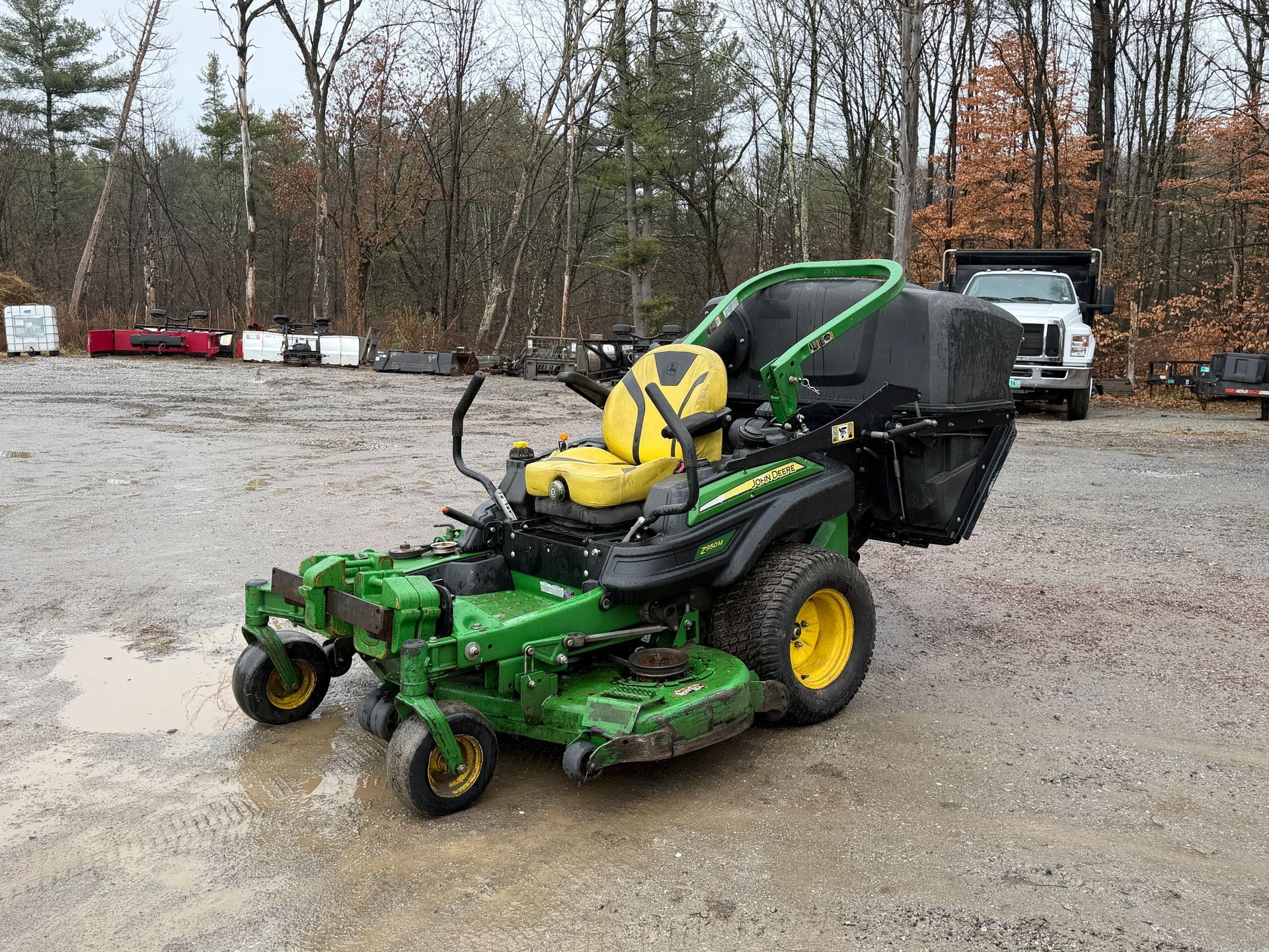 Green and yellow John Deere zero-turn lawnmower.